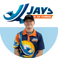 Meet the team! A person in a Jays Heating, Air, and Plumbing uniform stands proudly in front of a logo with matching branding.