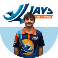 Meet the team: A person wearing a Jay's Heat, Air, Plumbing branded shirt stands in front of the company's logo.